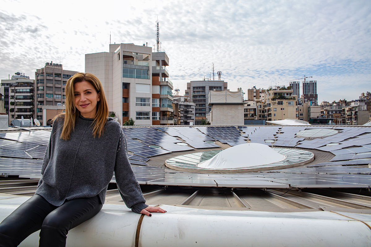 Carol Ayat stands proudly beside a solar panel system she designed and installed at the ABC Achrafieh Shopping Mall in Beirut, Lebanon. Photo: UN Women/ Lauren Rooney