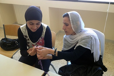 Hiba Kamal, a Syrian refugee, learns needlework technique from a Lebanese woman at a workshop by Amel Association, supported by UN Women Fund for Gender Equality. Photo courtesy of Amel Association