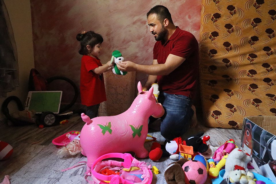 Mahmoud Charary enjoys playtime with his one-year-old daughter, Jouri. Photo: Ramzi Haidar/Dar Al Mussawir for UN Women