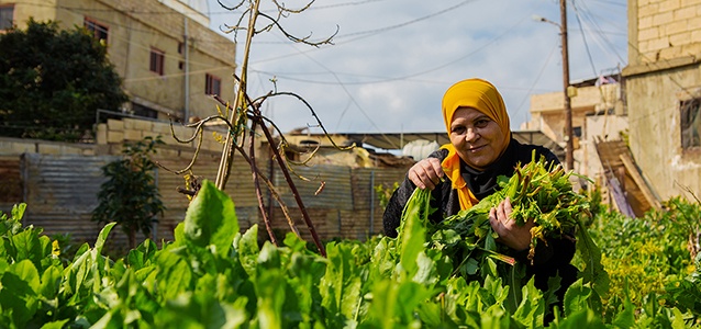 Aida Ghadban with her homegrown rooftop plants. Photo: UN Women/Lauren Rooney